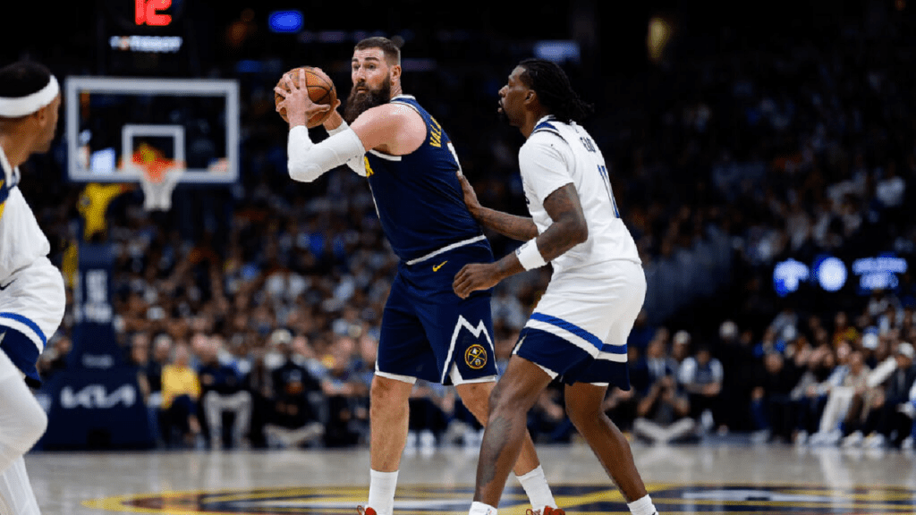 Denver Nuggets center Jonas Valanciunas (17) controls the ball as Minnesota Timberwolves center Naz Reid (11) guards in the fourth quarter during game five of the first round of the 2026 NBA Playoffs at Ball Arena.
