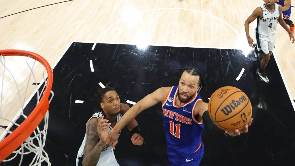 New York Knicks guard Jalen Brunson (11) shoots as San Antonio Spurs guard Devin Vassell (24) defends during game five of the 2026 NBA Finals at Frost Bank Center.