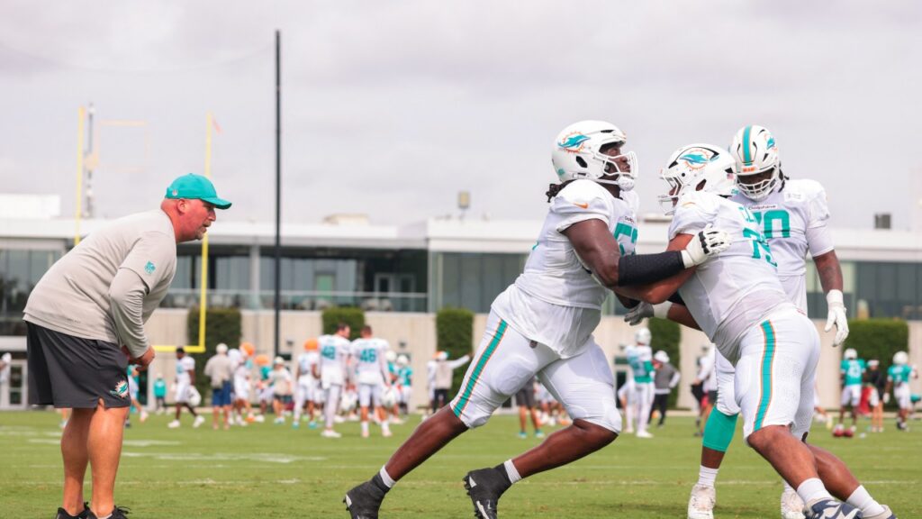 Aug 3, 2026; Miami Gardens, FL, USA; Miami Dolphins offensive line coach Zach Yenser watches offensive tackle Patrick Paul (52) work with offensive tackle Kevin Cline (79) during practice at Baptist Health Training Complex. Mandatory Credit: Sam Navarro-Imagn Images

