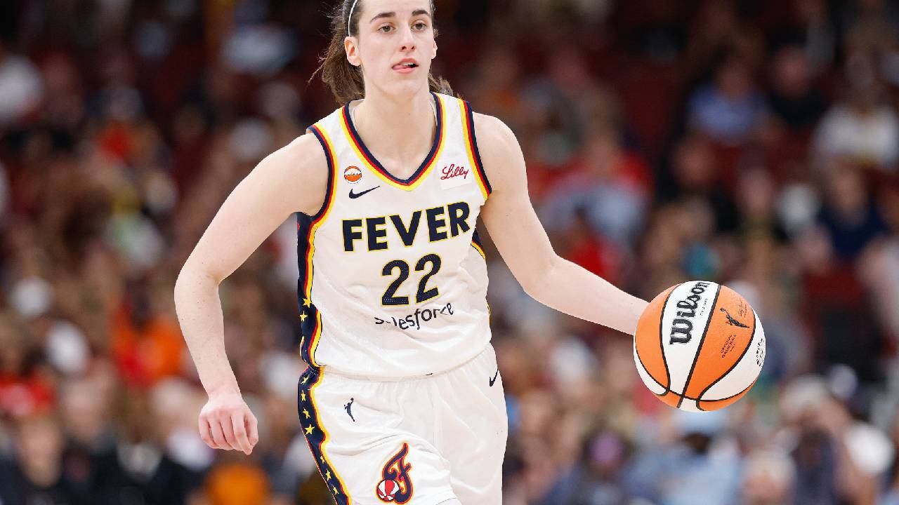 Indiana Fever guard Caitlin Clark (22) brings the ball up court against the Chicago Sky during the first half at United Center.