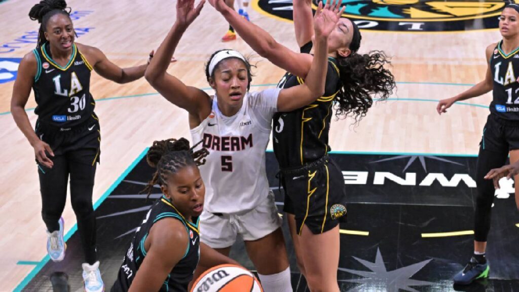 Los Angeles Sparks guard Ariel Atkins (7), forward Dearica Hamby (5) and Atlanta Dream forward Angel Reese (5) go for a rebound in the first half at Crypto.com Arena.