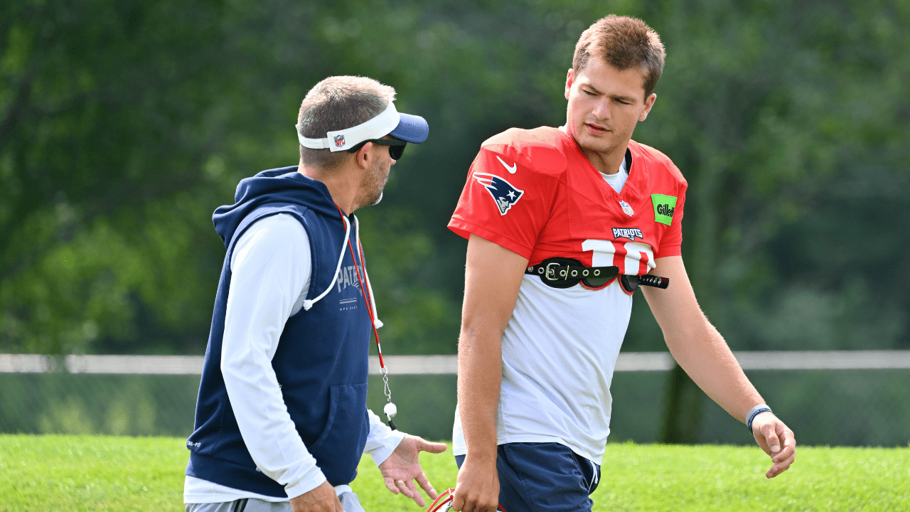 Jul 28, 2026; Foxborough, MA, USA; New England Patriots offensive coordinator Josh McDaniels and quarterback Drake Maye (10) speak as they walk to practice for training camp at Gillette Stadium. Mandatory Credit: Eric Canha-Imagn Images