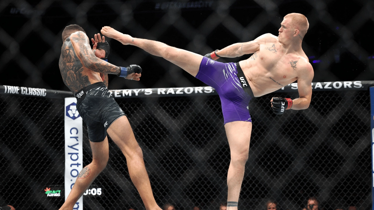 Apr 26, 2025; Kansas City, Missouri, UNITED STATES; Ian Machado Garry (red gloves) fights Carlos Prates (blue gloves) during UFC Fight Night at T-Mobile Center. Mandatory Credit: William Purnell-Imagn Images
