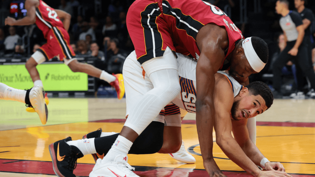 Jan 13, 2026; Miami, Florida, USA; Miami Heat center Bam Adebayo (13) lands on top of Phoenix Suns guard Devin Booker (1) during the first quarter at Kaseya Center. Mandatory Credit: Sam Navarro-Imagn Images. Tracy McGrady. 