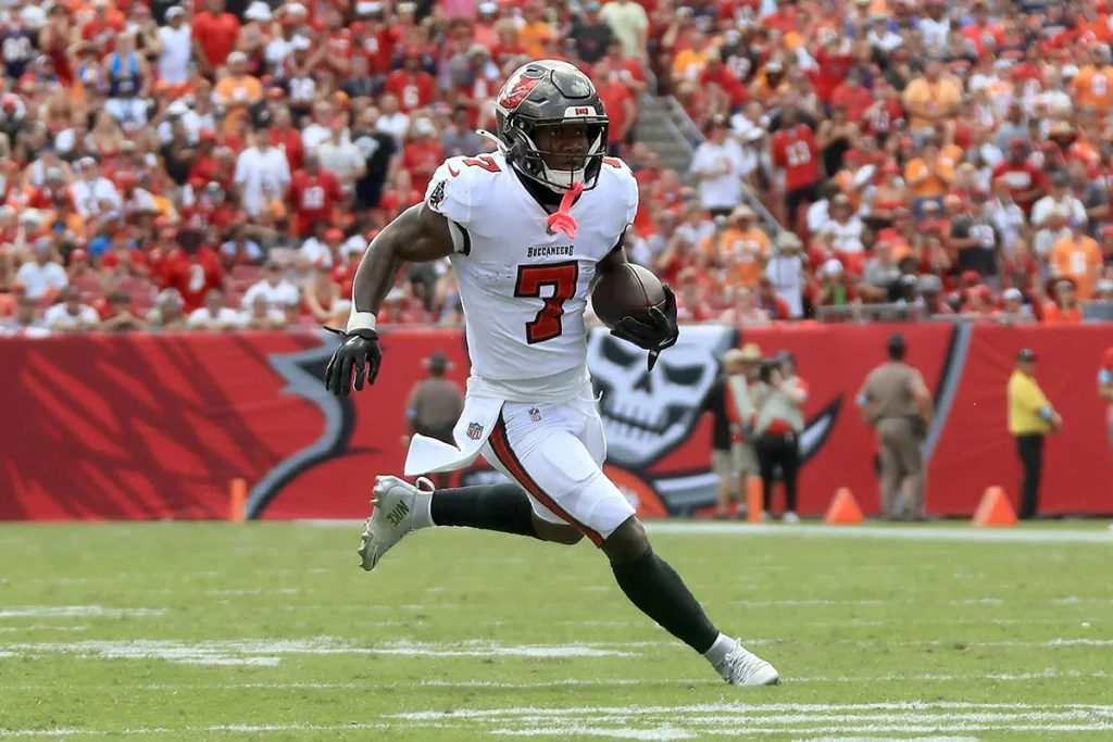 Tampa Bay Buccaneers running back Bucky Irving carrying the football in open field.