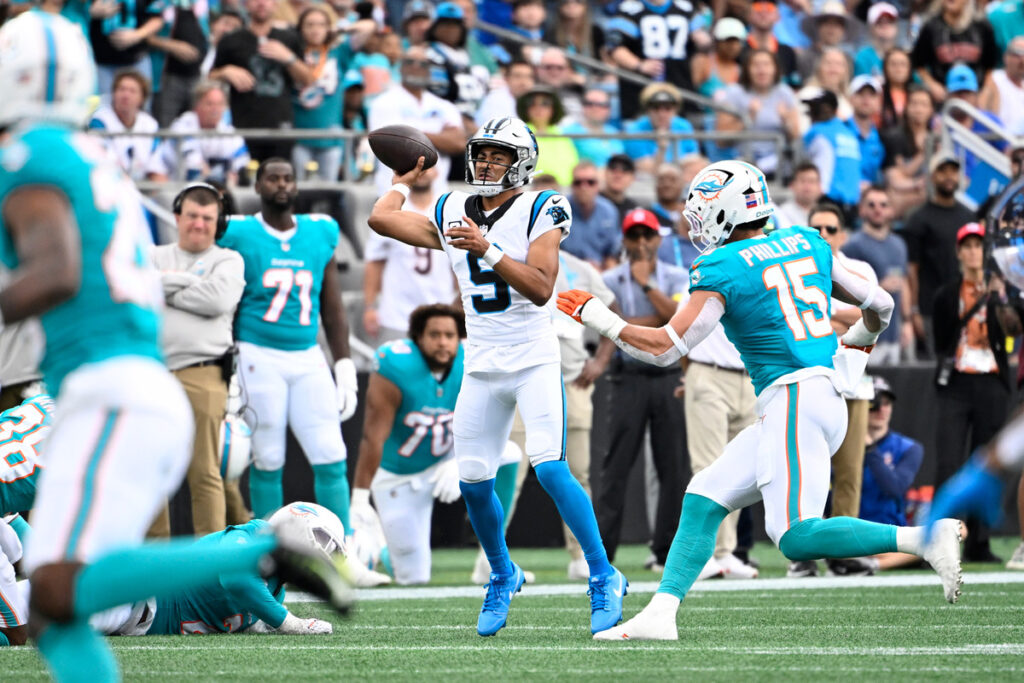 Oct 5, 2025; Charlotte, North Carolina, USA; Carolina Panthers quarterback Bryce Young (9) passes the ball as Miami Dolphins linebacker Jaelan Phillips (15) pressures in the second quarter at Bank of America Stadium. Mandatory Credit: Bob Donnan-Imagn Images
