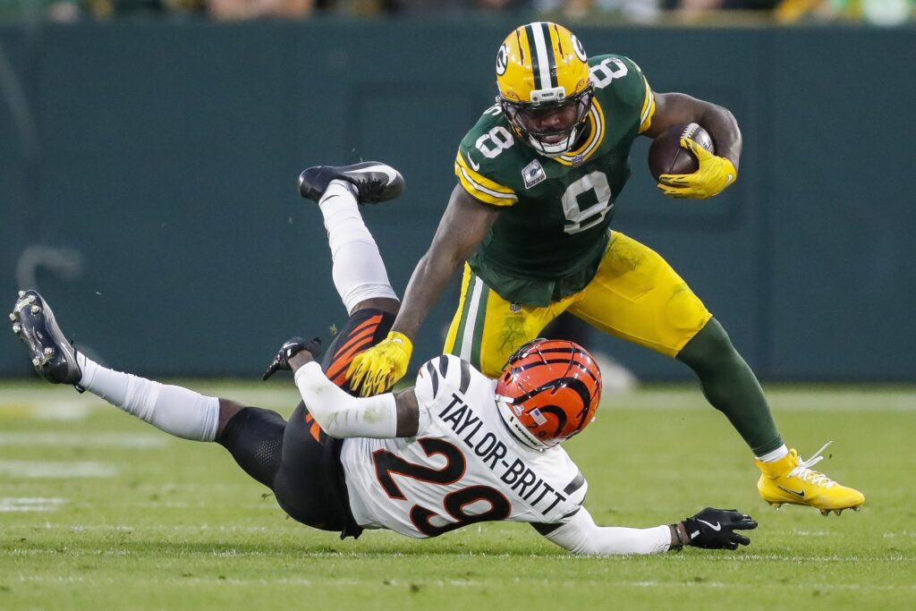 Packers' Josh Jacobs stiff-arms Bengals' Cam Taylor-Britt