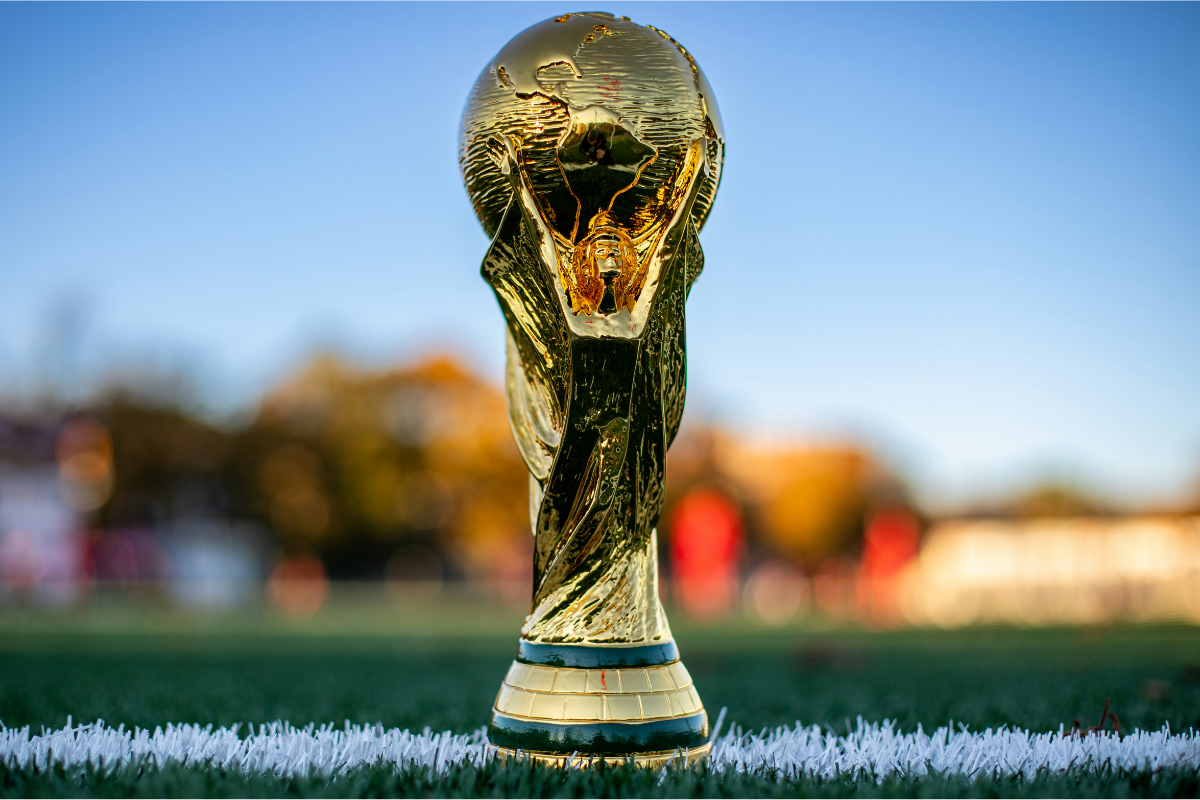 The World Cup trophy sitting on a field