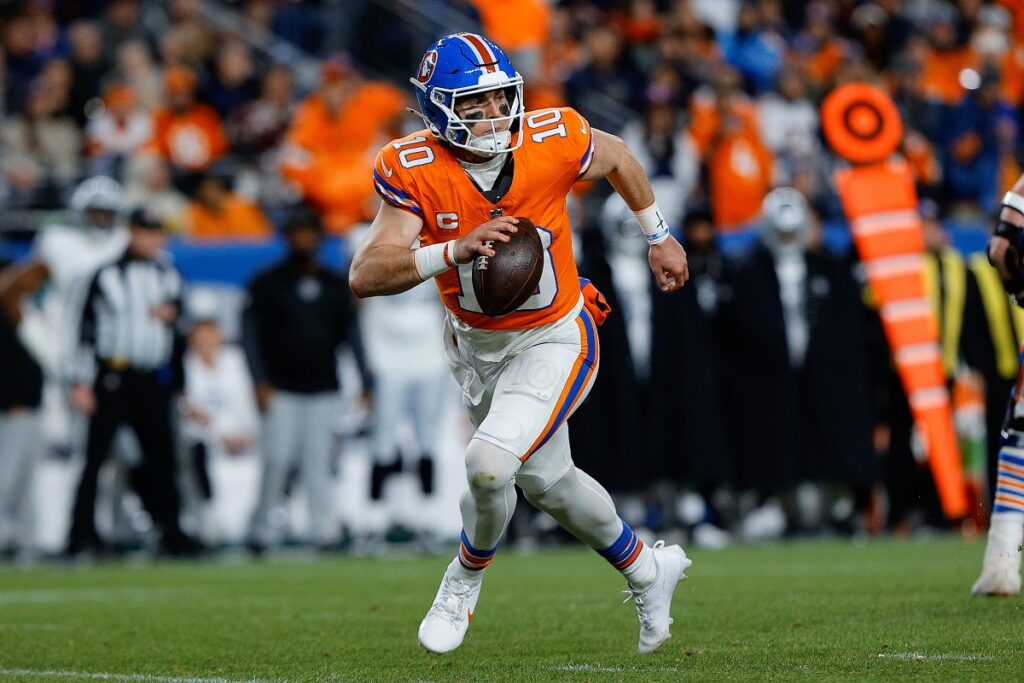 Denver Broncos quarterback Bo Nix (10) scrambles with the ball in the fourth quarter at Empower Field at Mile High.