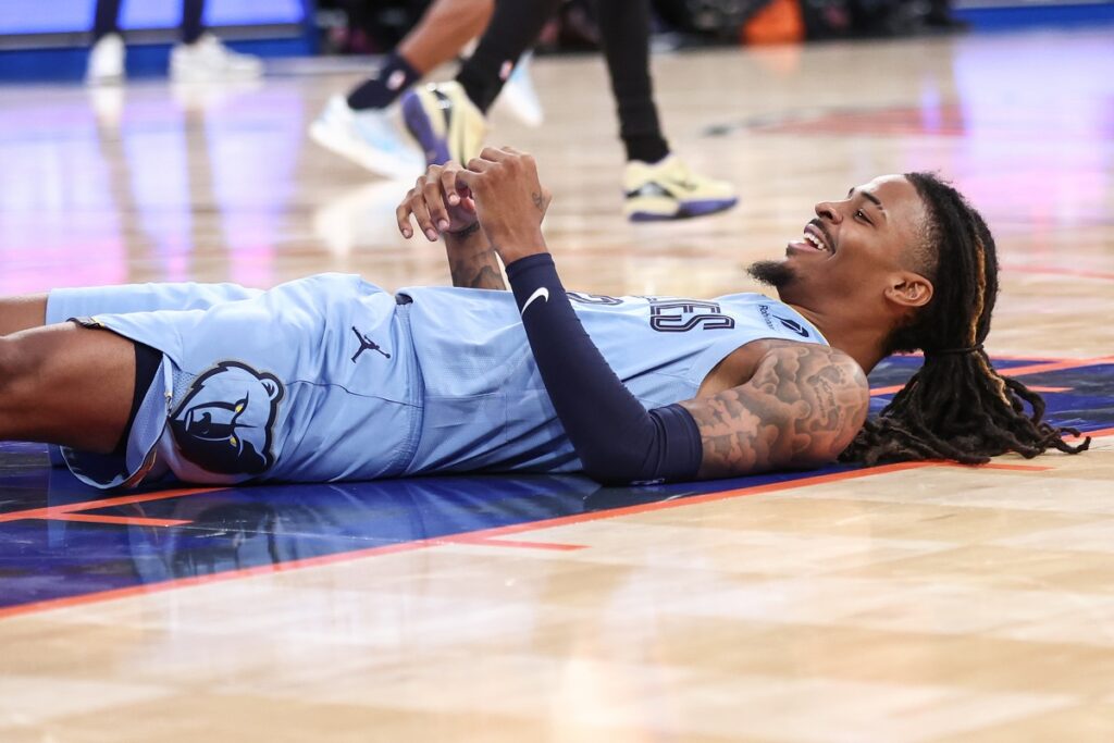 Memphis Grizzlies guard Ja Morant (12) lays on the court after attempting to score in the third quarter against the New York Knicks at Madison Square Garden.