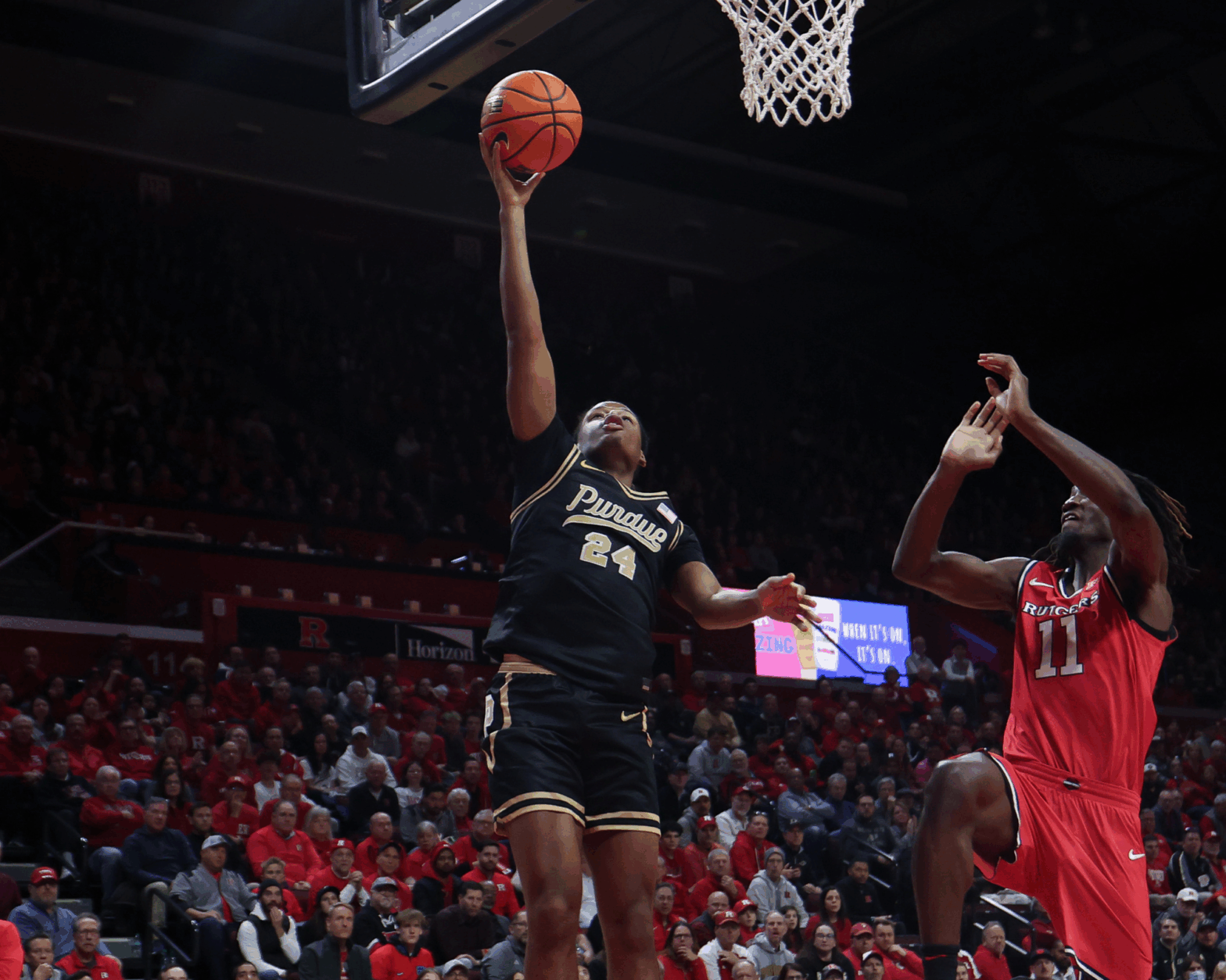 Dec 2, 2025; Piscataway, New Jersey, USA; Purdue Boilermakers guard Gicarri Harris (24) drives to the basket as Rutgers Scarlet Knights forward Christopher Nwuli (11) defends during the first half at Jersey Mike's Arena. Mandatory Credit: Vincent Carchietta-Imagn Imagesu