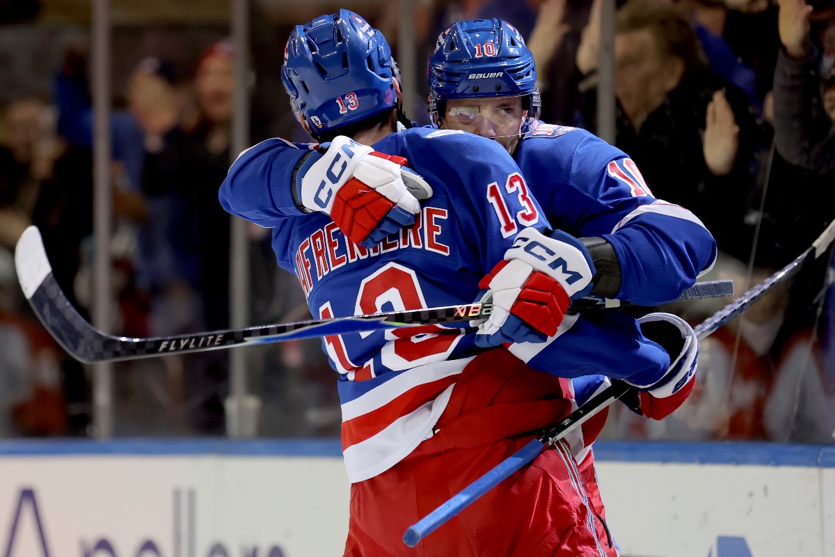 Artemi Panarin and Alexis Lafreniere embrace each other during the Rangers-Flyers game