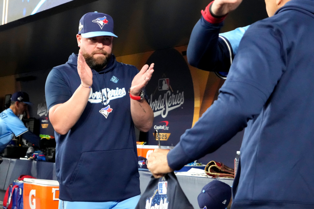 Caption:
Oct 31, 2025; Toronto, Ontario, CAN; Toronto Blue Jays manager John Schneider (14) reacts in the dugout before game six of the 2025 MLB World Series between the Toronto Blue Jays and the Los Angeles Dodgers at Rogers Centre. Mandatory Credit: John E. Sokolowski-Imagn Images