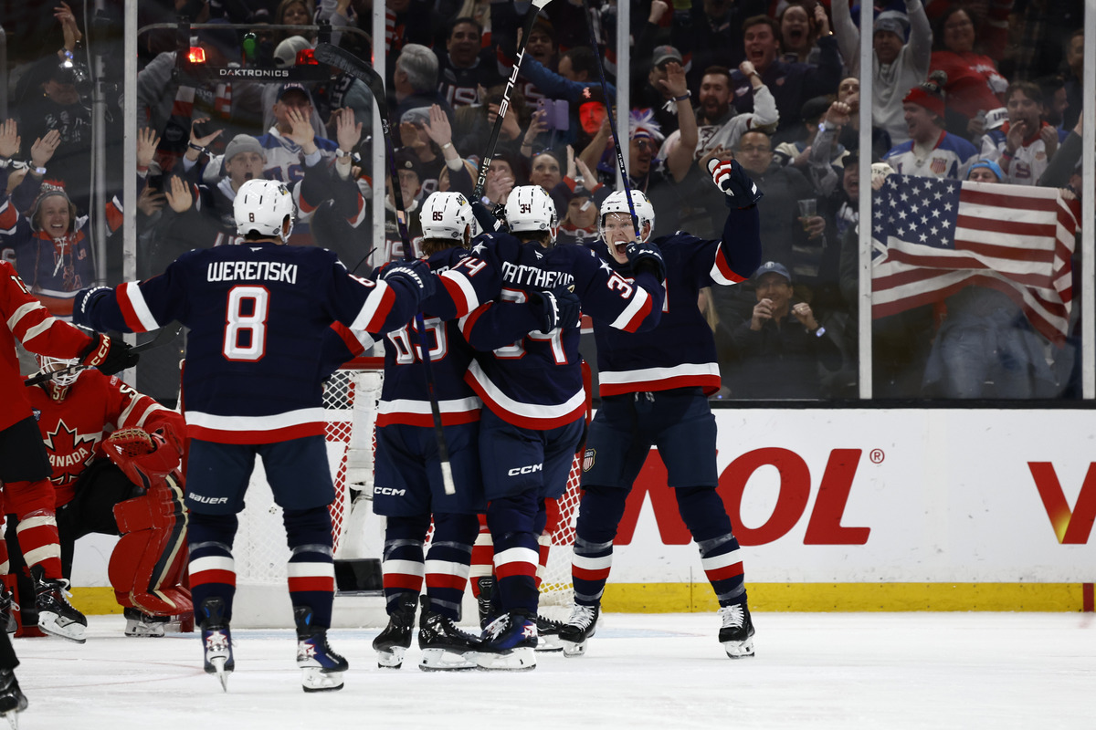 Members of the United States celebrate a goal scored at the 4 Nations Face-Off.