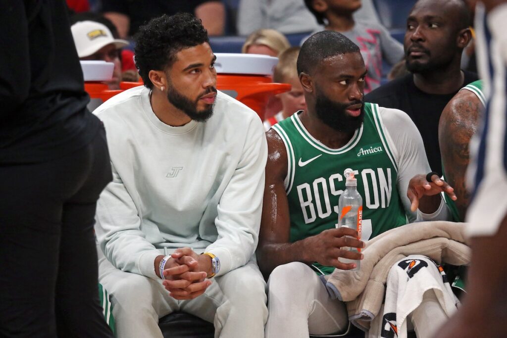 Jayson Tatum and Jaylen Brown watch the Celtics game. 