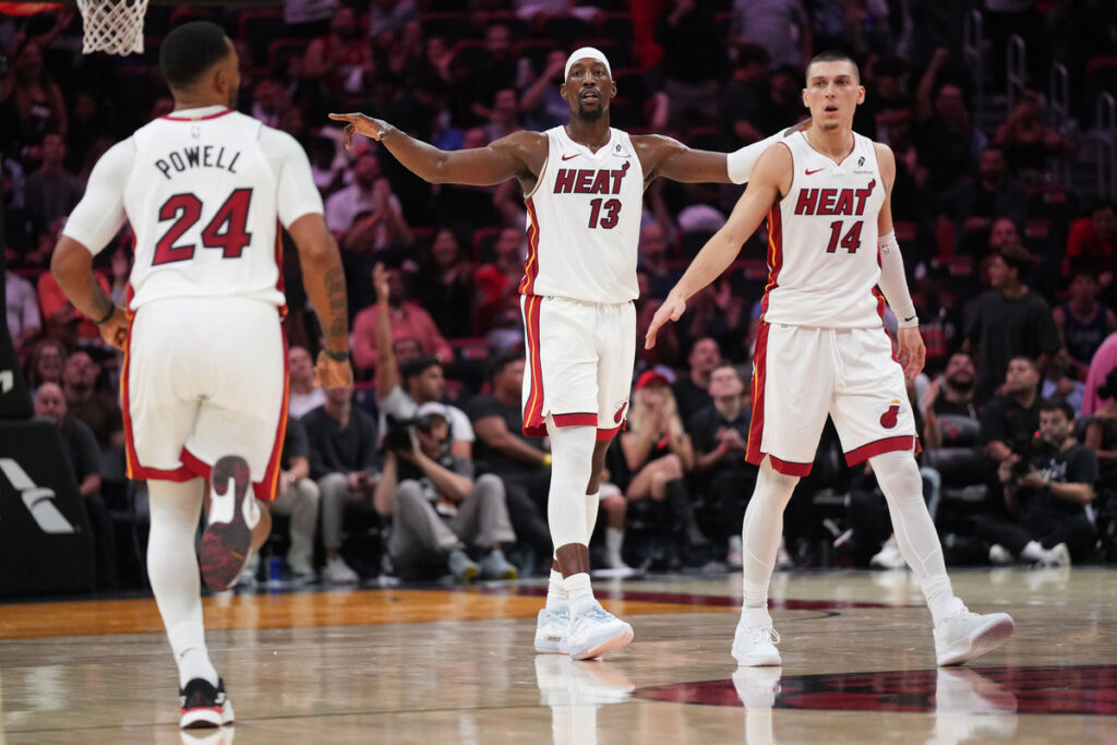 Dec 1, 2025; Miami, Florida, USA; Miami Heat center Bam Adebayo (13), guard Norman Powell (24) and guard Tyler Herro (14) get back on defense against the Los Angeles Clippers during the second half at Kaseya Center. Mandatory Credit: Jim Rassol-Imagn Images