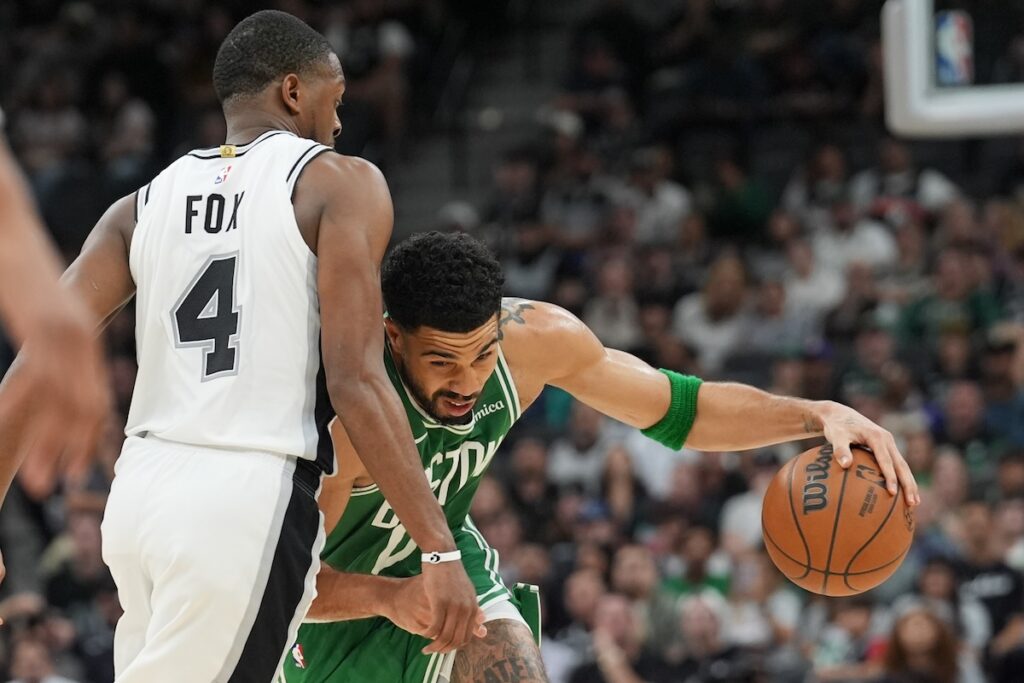 Mar 10, 2026; San Antonio, Texas, USA; Boston Celtics forward Jayson Tatum (0) drives against San Antonio Spurs guard De'aaron Fox (4) in the second half at Frost Bank Center. Mandatory Credit: Daniel Dunn-Imagn Images