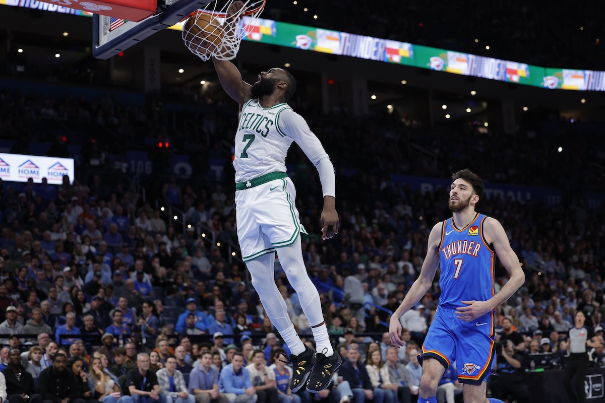 Mar 12, 2026; Oklahoma City, Oklahoma, USA; Boston Celtics guard/forward Jaylen Brown (7) goes up for a dunk in front of Oklahoma City Thunder center/forward Chet Holmgren (7) during the fourth quarter at Paycom Center. Mandatory Credit: Alonzo Adams-Imagn Images