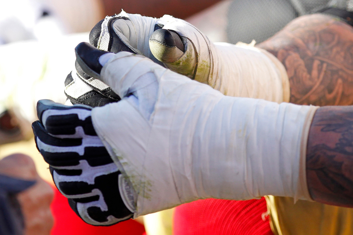 Wrist tape on a football player. Why Do Football Players Tape Their Arms? The Real Reasons Explained