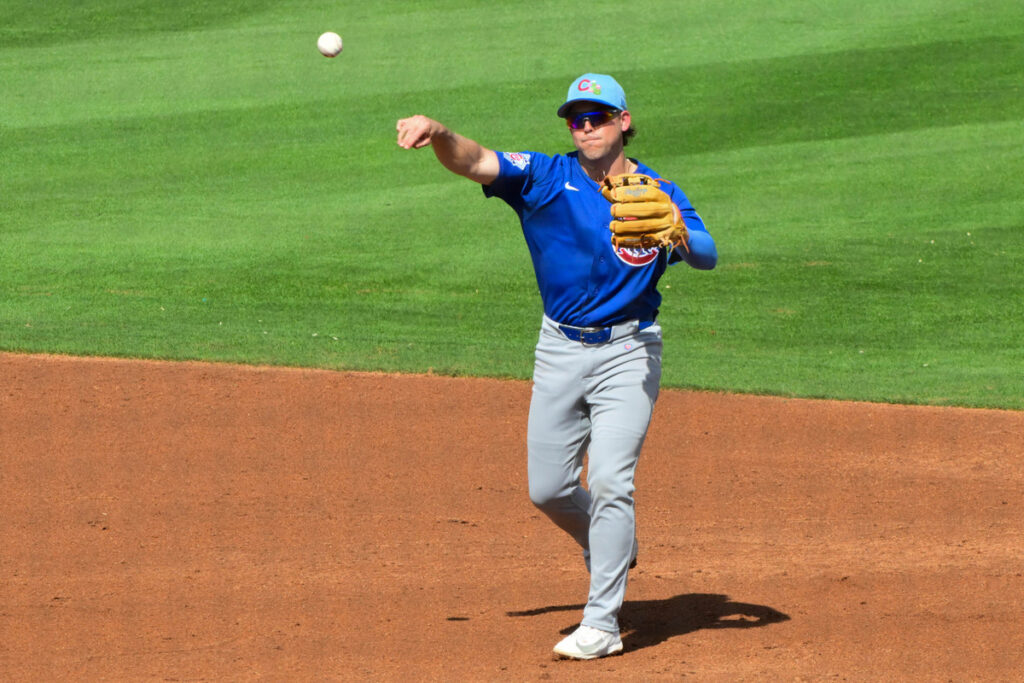 Scott Kingery throws to first base during a Cubs' Spring Training game.