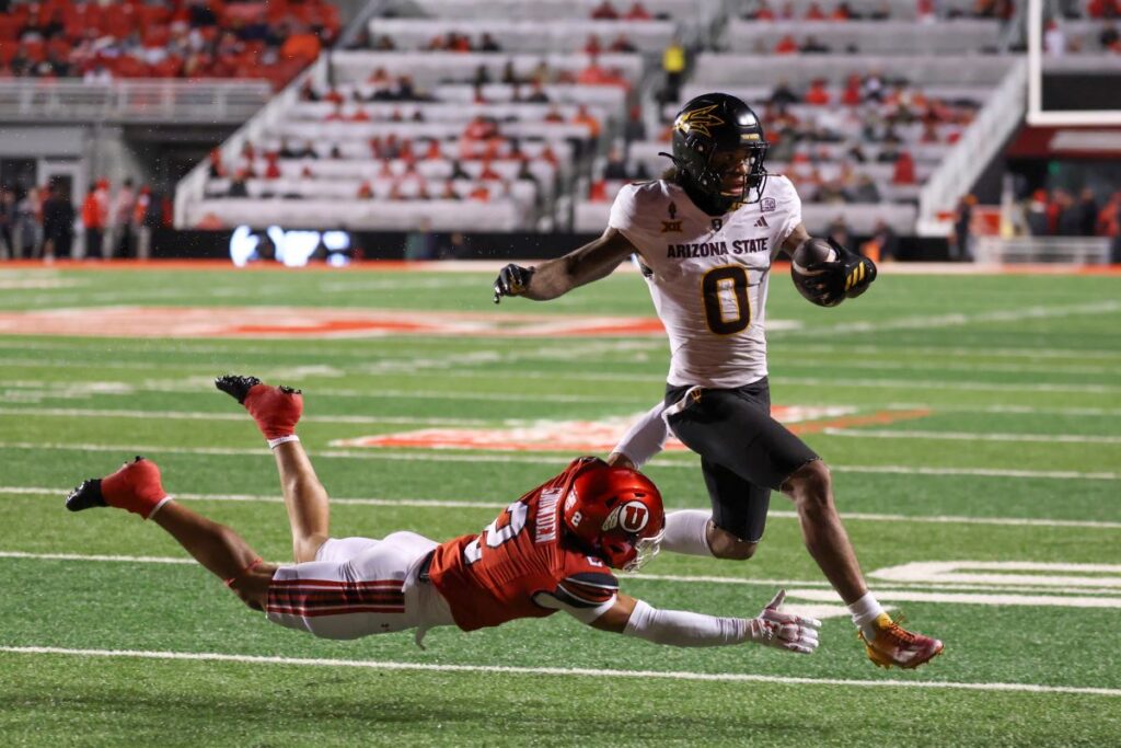 Jordyn Tyson escaping a defender as he runs into the endzone against Utah