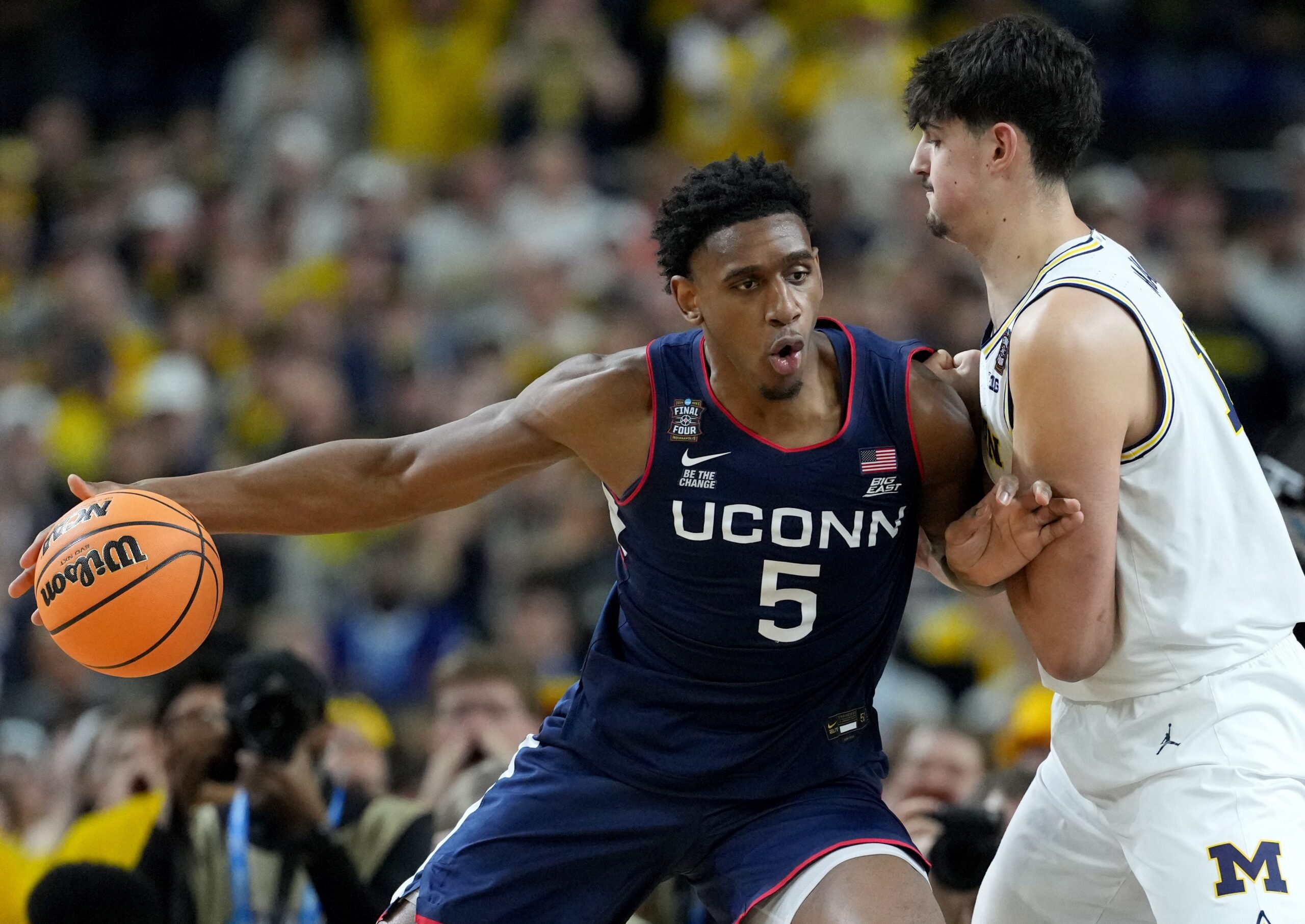UConn Huskies forward and NBA Draft prospect Tarris Reed Jr. (5) backs down Michigan Wolverines center Aday Mara (15) on Monday, April 6, 2026, during the NCAA men’s basketball national championship game at Lucas Oil Stadium in Indianapolis.