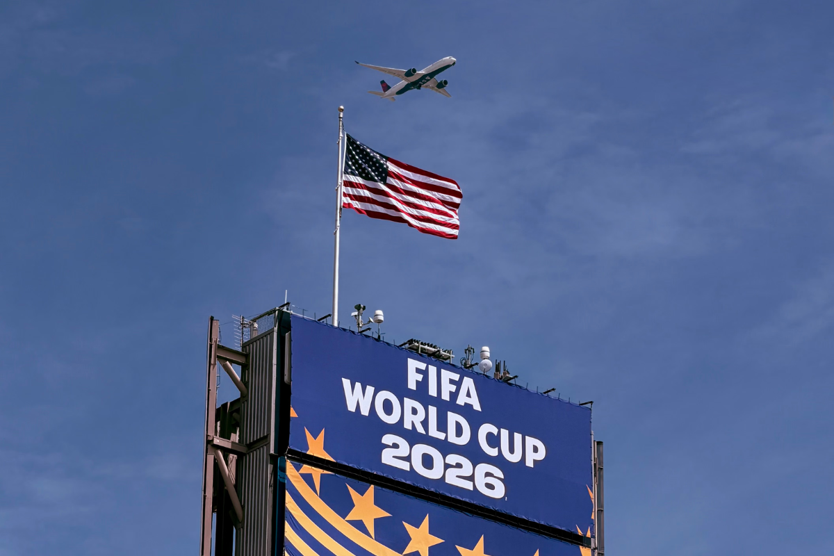 Plane flying over world cup stadium.