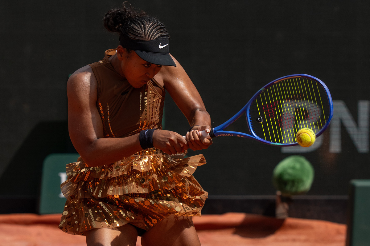 Naomi Osaka returns a shot.