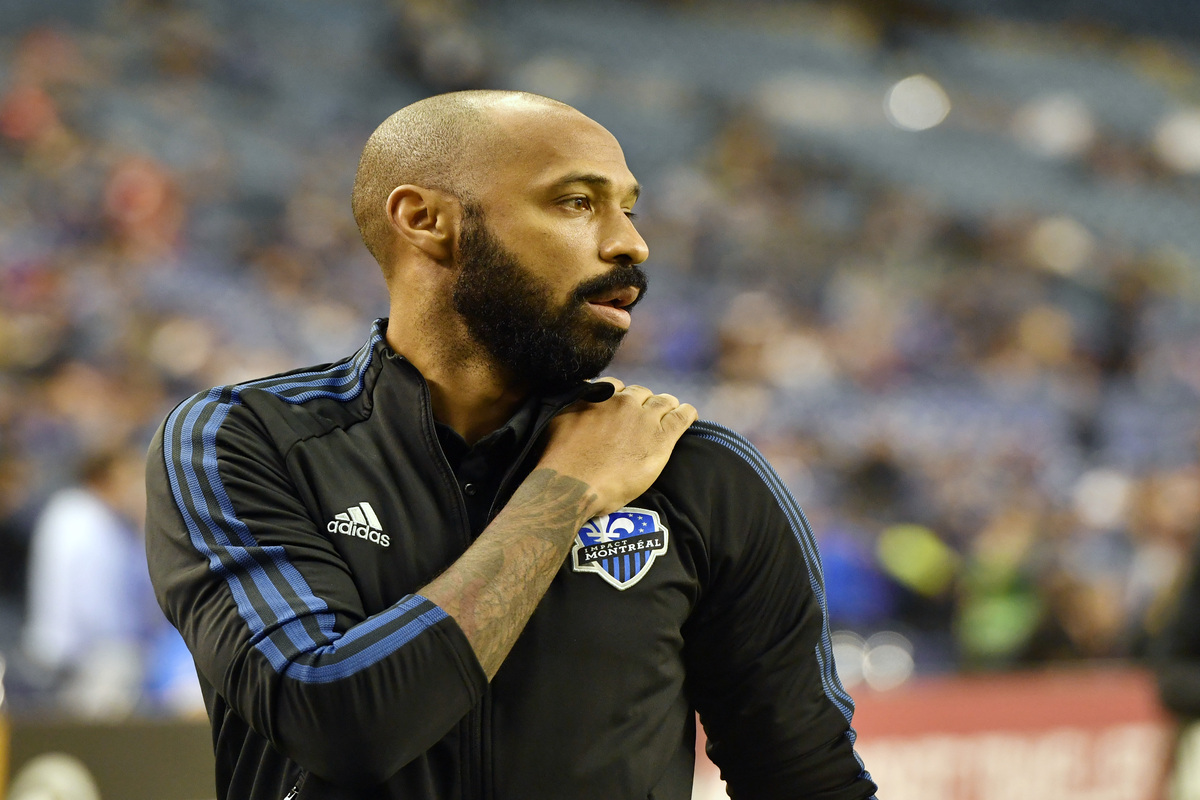 Thierry Henry, one of the world's most legendary soccer players, walks on the field.