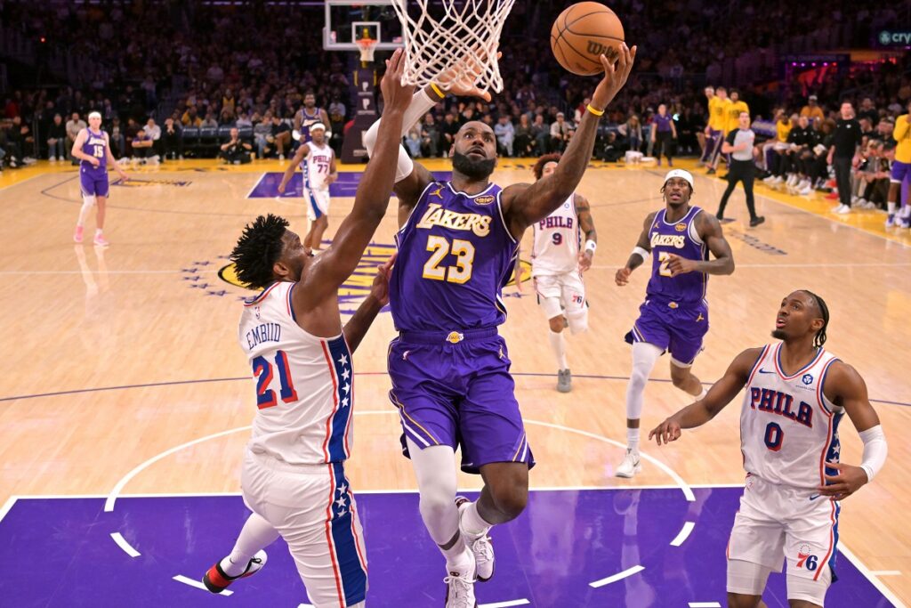 Los Angeles Lakers Forward, LeBron James, drives past Philadelphia 76ers center, Joel Embiid.