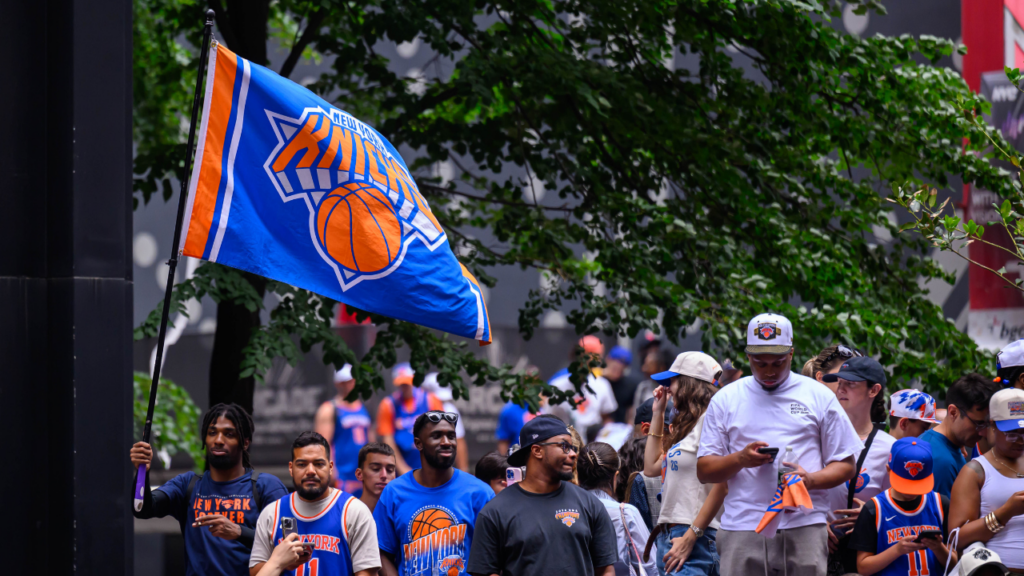 Jun 18, 2026; New York, NY, USA; A New York Knicks flag flies above the crowd during the New York Knicks Championship Parade through the Canyon of Heroes. Mandatory Credit: Brenden Willsch-Imagn Images