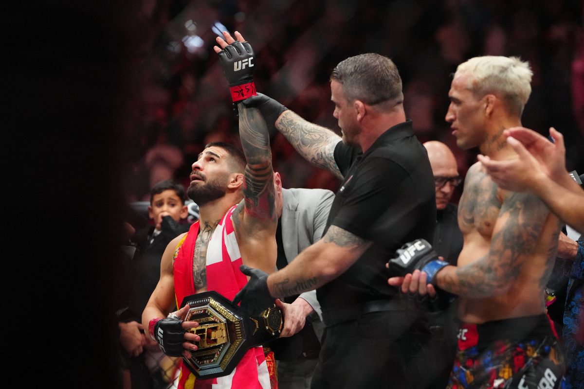 Ilia Topuria having the championship wrapped around his waist after a fight
