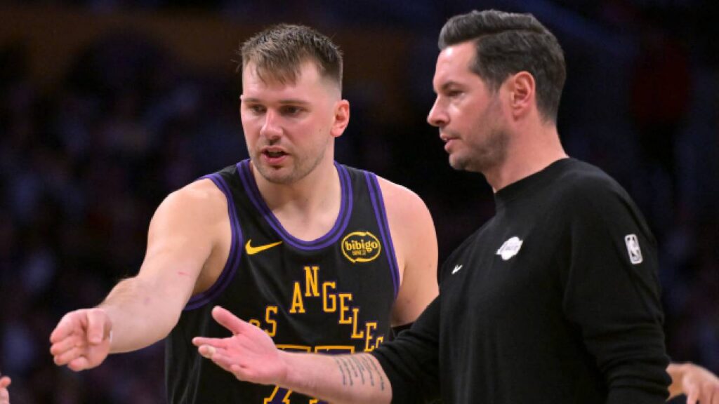 Los Angeles Lakers guard Luka Doncic (77) talks with head coach JJ Redick during a time out in the second half against the Memphis Grizzlies at Crypto.com Arena.