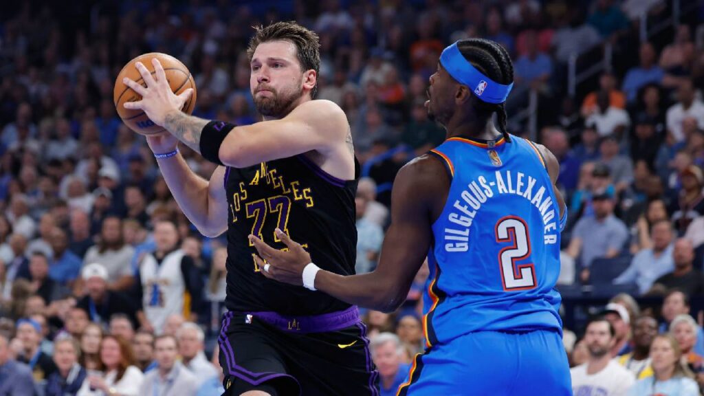 Los Angeles Lakers guard Luka Doncic (77) passes as Oklahoma City Thunder guard Shai Gilgeous-Alexander (2) defends during the first quarter at Paycom Center.