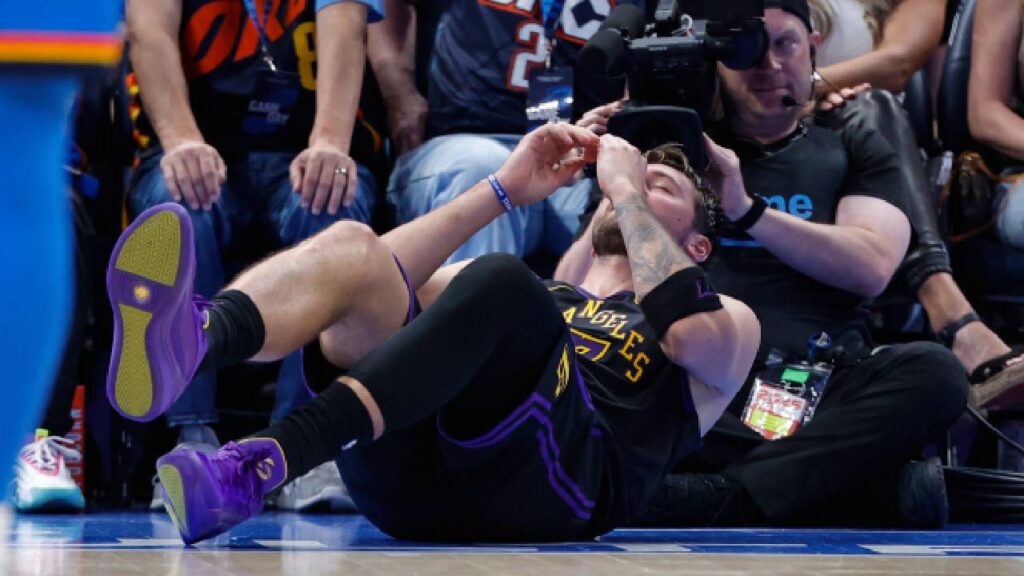 Los Angeles Lakers guard Luka Doncic (77) falls to the court after an injury against the Oklahoma City Thunder during the second half at Paycom Center.