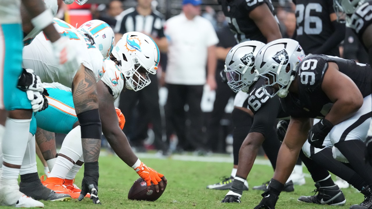 Miami Dolphins Week 1 matchup against the Las Vegas Raiders shows both teams lined up at the line of scrimmage at Allegiant Stadium, highlighting the physical battle in the trenches.